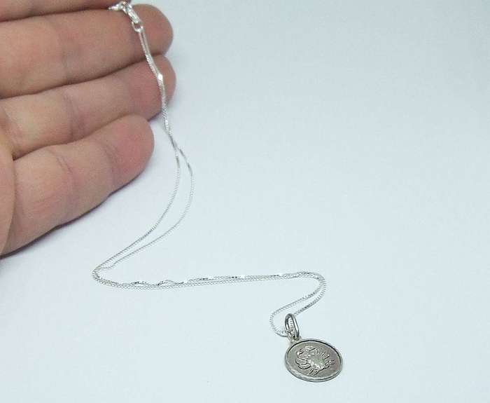 A vintage sterling silver Cancer Zodiac sign pendant with a sterling silver necklace