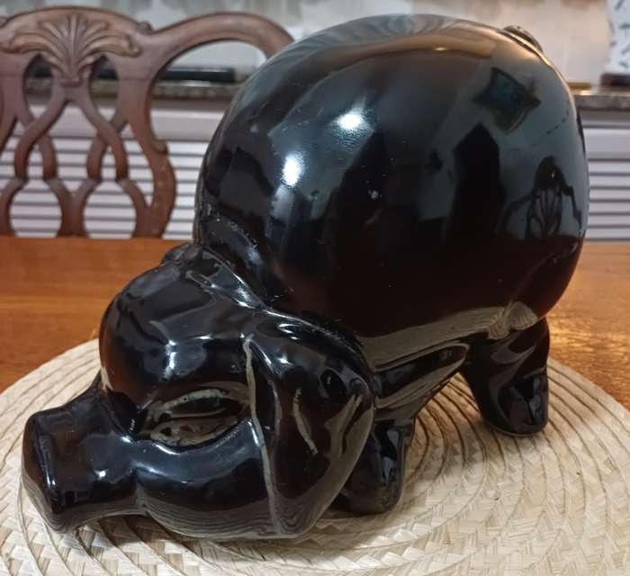 Large Black Porcelain piggy bank representing a pig and dating from the 1980s.