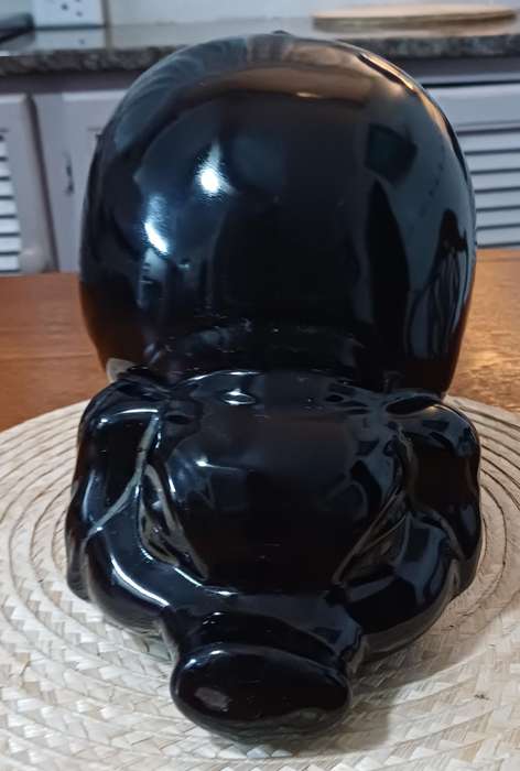 Large Black Porcelain piggy bank representing a pig and dating from the 1980s.