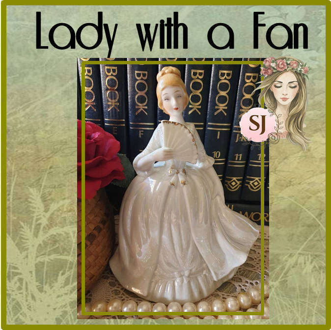Beautiful vintage porcelain figurine of a lady with a Fan
