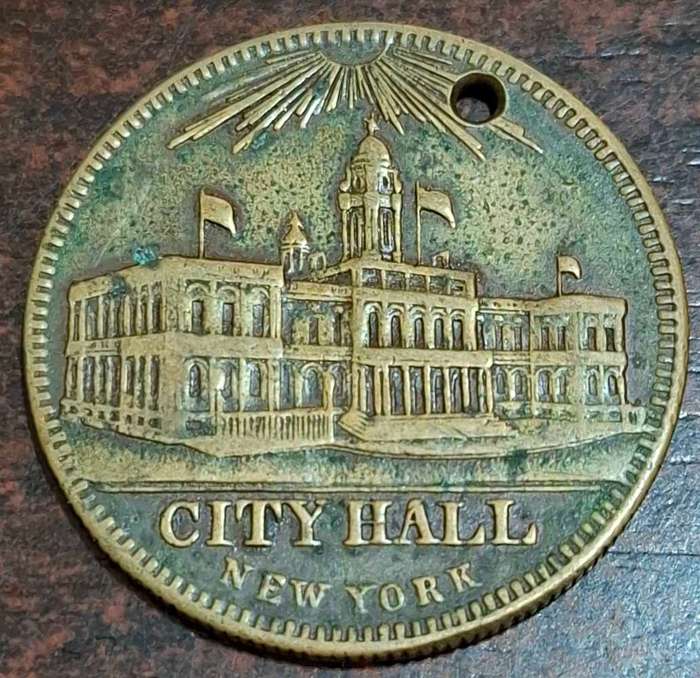 vintage game counter token from the 1850s, featuring New York City Hall