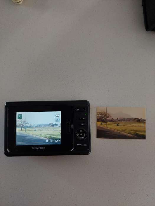 Poloroid Pogo instant digital camera (LIKE NEW) still has plastics on the camera.