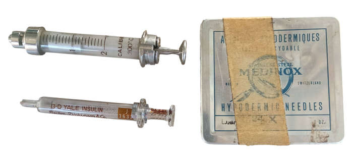 2 Vintage glass and metal syringes with 9 needles in metal box