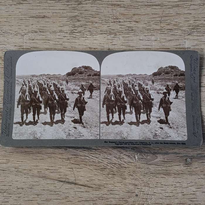 Boer War stereoscope card - Her Majesty's Heroes marching into Colesberg, S.A