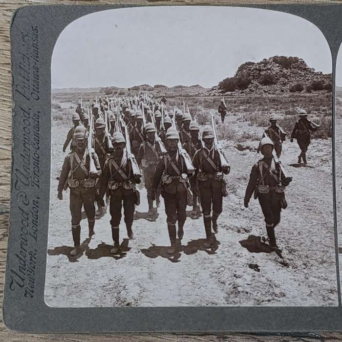 Boer War stereoscope card - Her Majesty's Heroes marching into Colesberg, S.A
