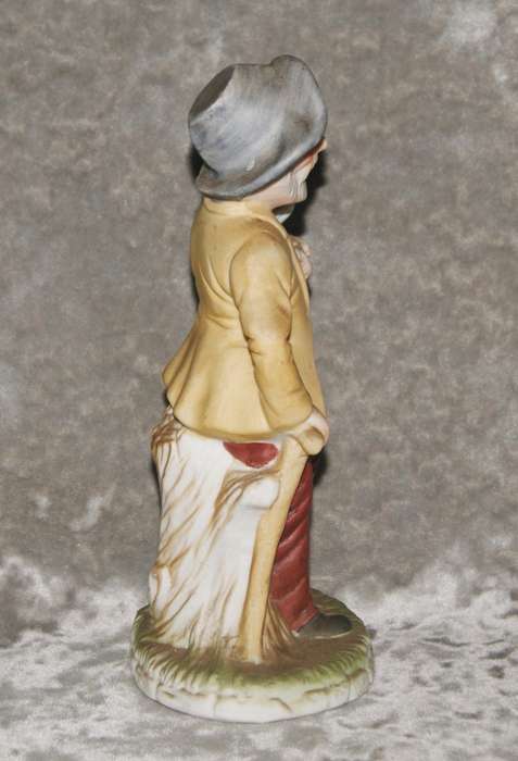 Vintage ceramic figurine of man holding dog