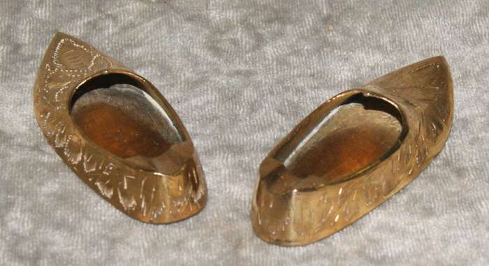 Pair of vintage brass etched shoes