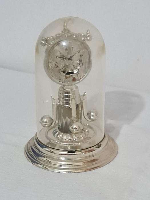 Clock that is not a clock. Small scent bottle inside.  Bottle no lid. Dial damage