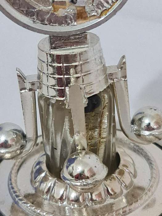 Clock that is not a clock. Small scent bottle inside.  Bottle no lid. Dial damage