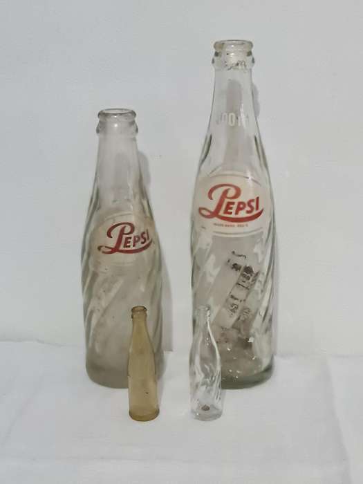 X4 Differant size and age Pepsi Cola bottles.