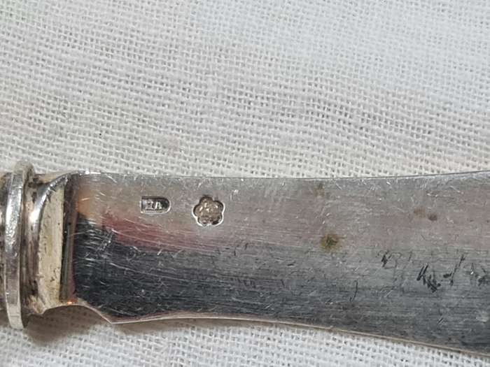 Three knifes with ornate handles and monogram on handle.