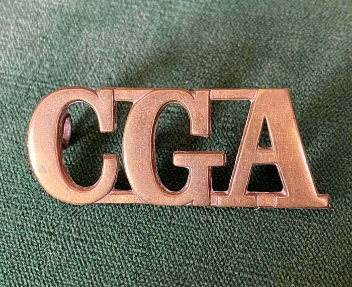 CAPE GARRISON ARTILLERY,BRASS SHOULDER TITLE-WORN FROM 1902- 2 LUGS