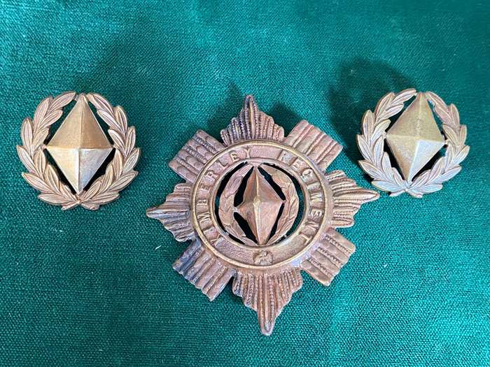 KIMBERLEY REGIMENT BRASS CAP AND COLLARS-WORN 1899-1939-VOIDED CENTRE-ONE LUG ON CAP MISSING