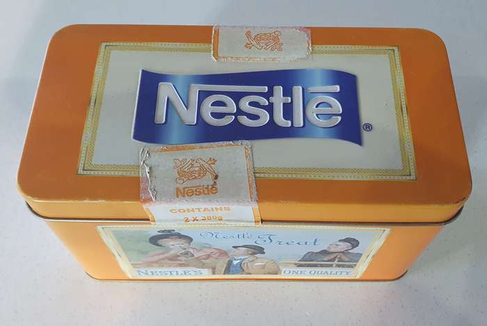 NESTLE tin as per photos
