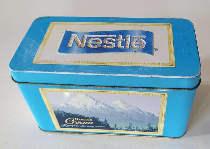 NESTLE tin as per photos