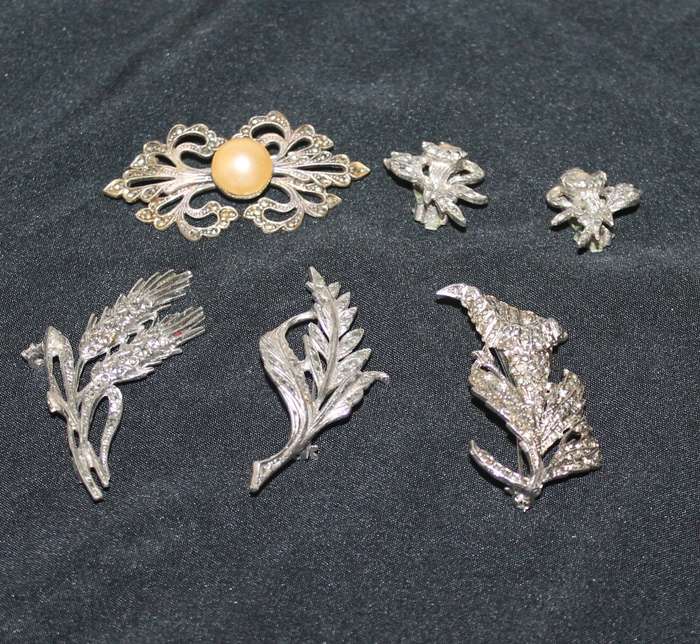 4 Marcasite Brooches and a pair of earrings