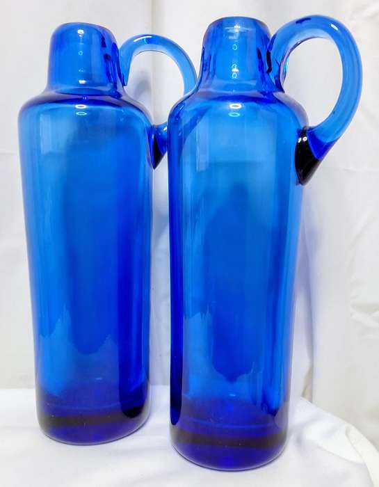 A pair of stunning vintage handmade blue glass heavy pitchers