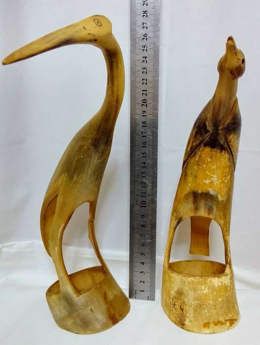 Two vintage carved horn birds