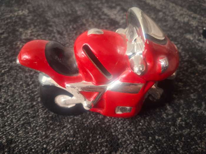 Red piggy bank motorbike