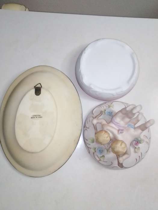 A Damsel and cherub Porcelain/polyresin wall plaque and a Cherub trinket lidded box.
