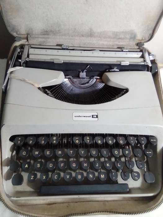 Vintage 1964 Underwood 310 Manuel Typewriter in Cary case with a receipt of repair & manual.