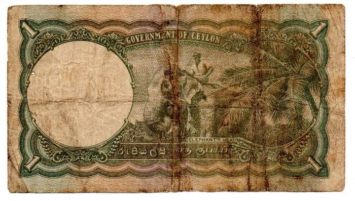 1941 Ceylon 1 Rupee Pick#34 edge tears and folds with 2 spike holes