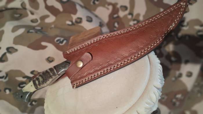 Damascus hunting bowie with bone and ramshorn handle