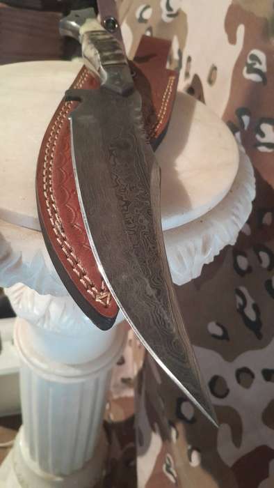 Damascus hunting bowie with bone and ramshorn handle