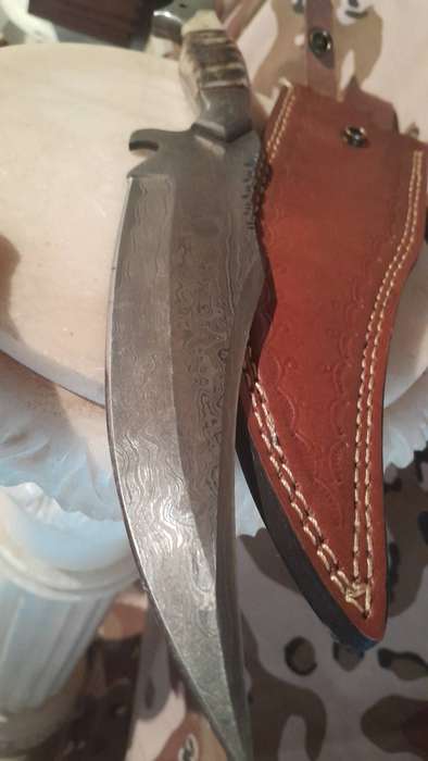 Damascus hunting bowie with bone and ramshorn handle