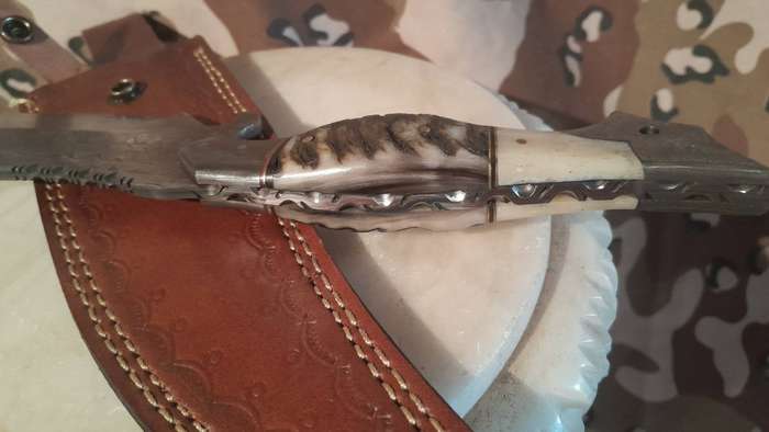Damascus hunting bowie with bone and ramshorn handle