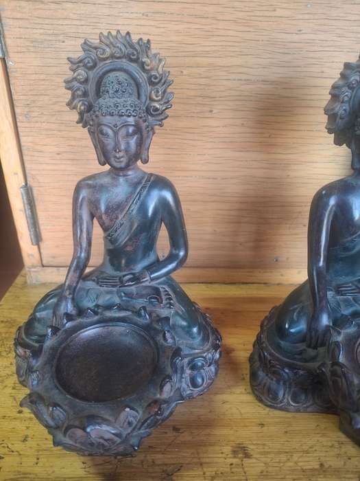 A pair of oriental resin made buddha candle holders