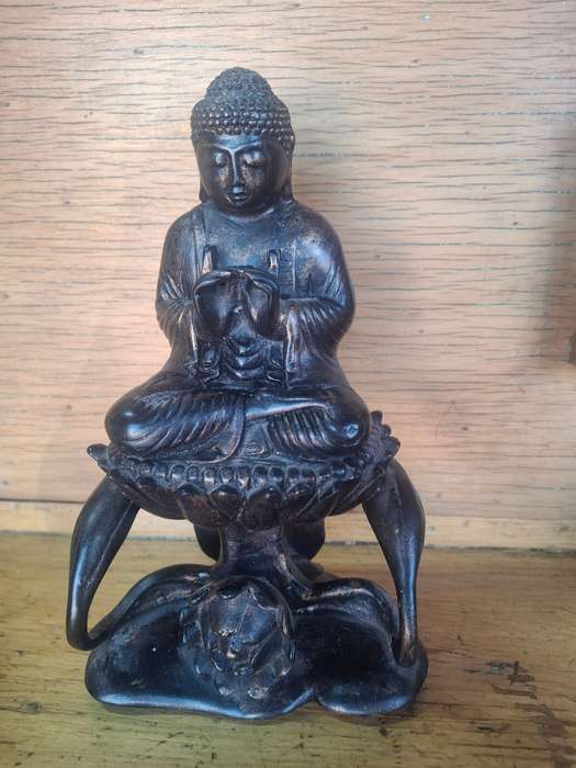 Interesting buddha sitting on a flower