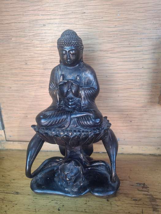 Interesting buddha sitting on a flower