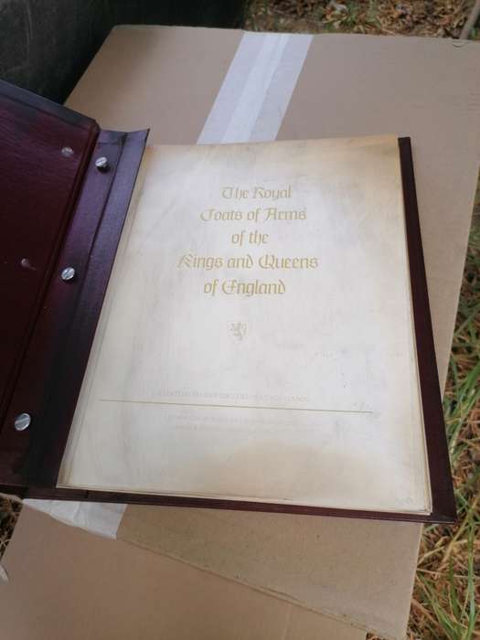 A BOOK of 22k Gold postage stamps, "The Royal Coats of Arms of the Kings and Queens of England", ple