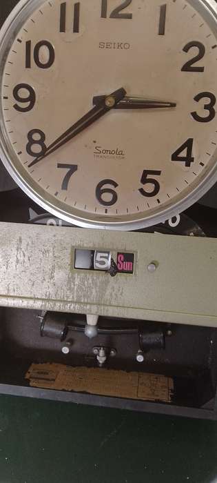A vintage Seiko wall chiming clock. For parts only. Not working front cover missing.