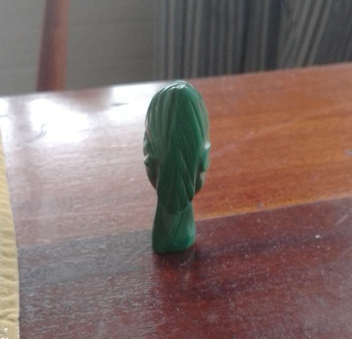 A Malachite "talking head" 7cm tall base 1.5cm across