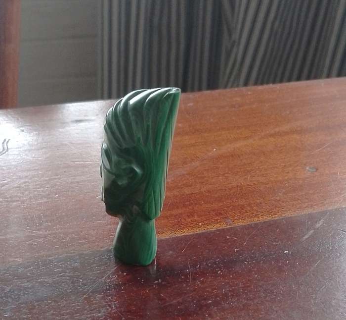 A Malachite "talking head" 7cm tall base 1.5cm across