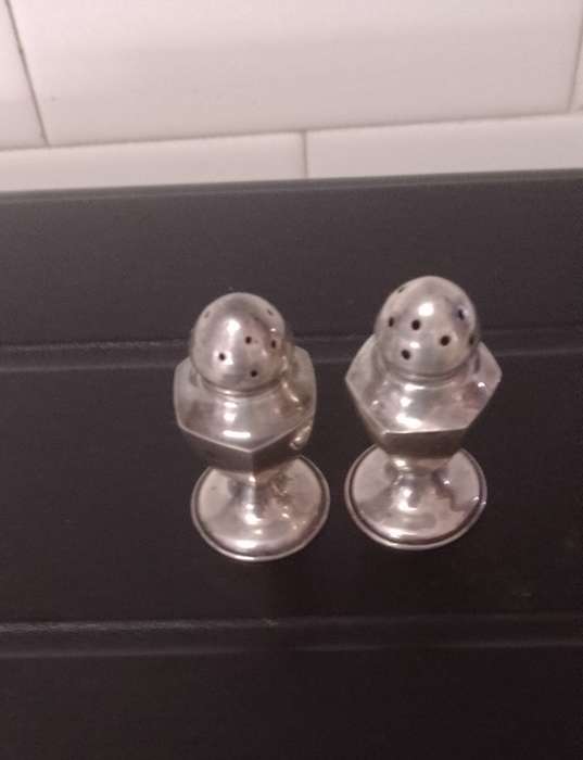 A pair of Sterling salt and pepper shakers 5cm tall base 2.5cm