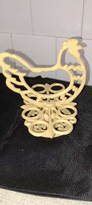A heavy cast iron -chicken egg holder