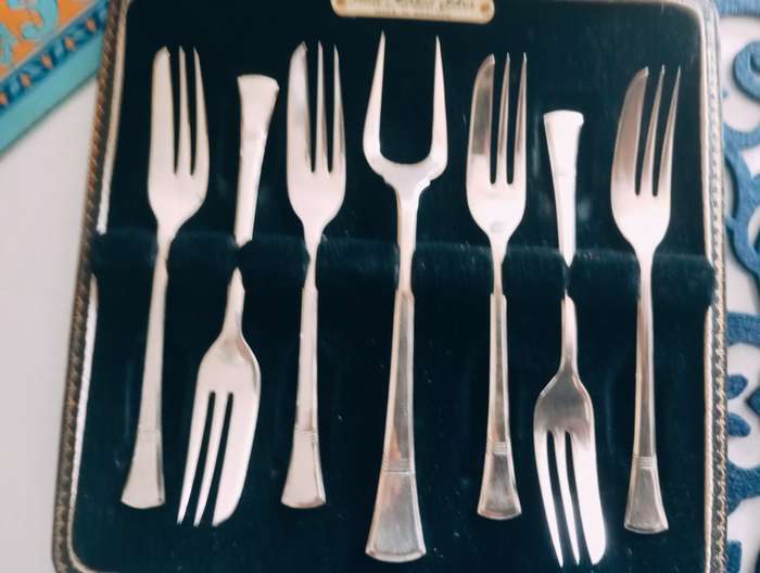 A fine boxed  set of sterling silver  cake forks