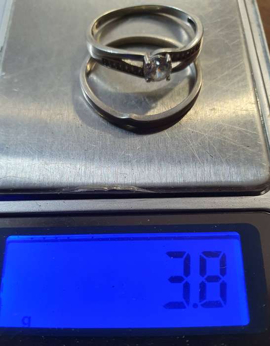 STERLING SILVER ENGAGEMENT RING WITH POLISHED STONE AND WEDDING BAND.