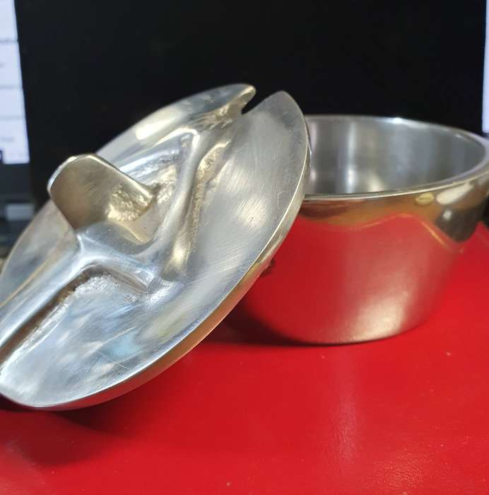 HANNEKE BRAND PEWTER AND STAINLESS SUGAR BOWL. WOMEN HOLDING LID .
