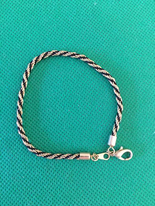 LOVELY GOLD TONE AND TIFARI CORD BRACELET