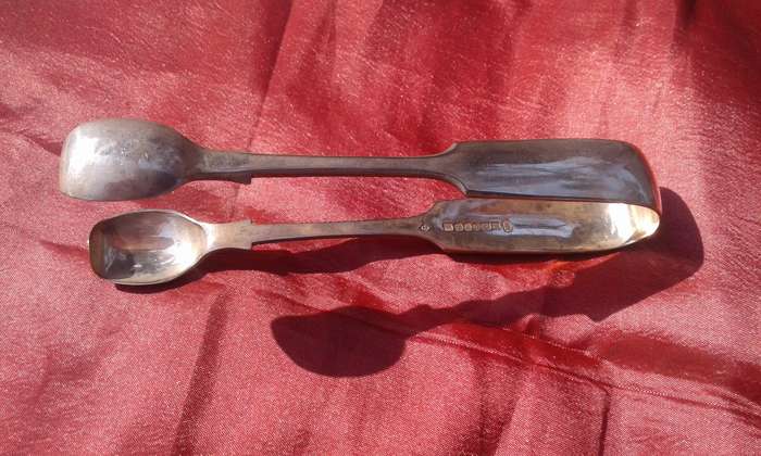 Silver-plated sugar tongs.