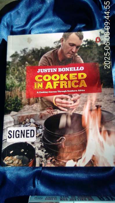 SIGNED.  "Cooked in Africa" Justin Bonello.  Soft cover.