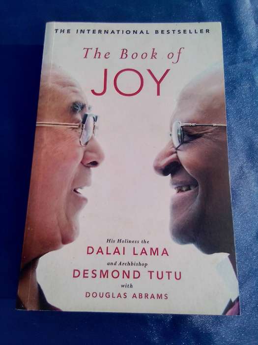 "The Book of Joy"  Dali Lama and Desmond Tutu.  Soft   cover.