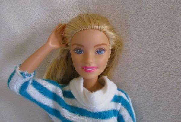 A pretty Mattel Barbie doll  in cute striped tracksuit