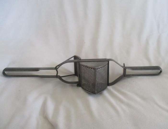 Two vintage potato kitchen utensils - masher and french fry cutter