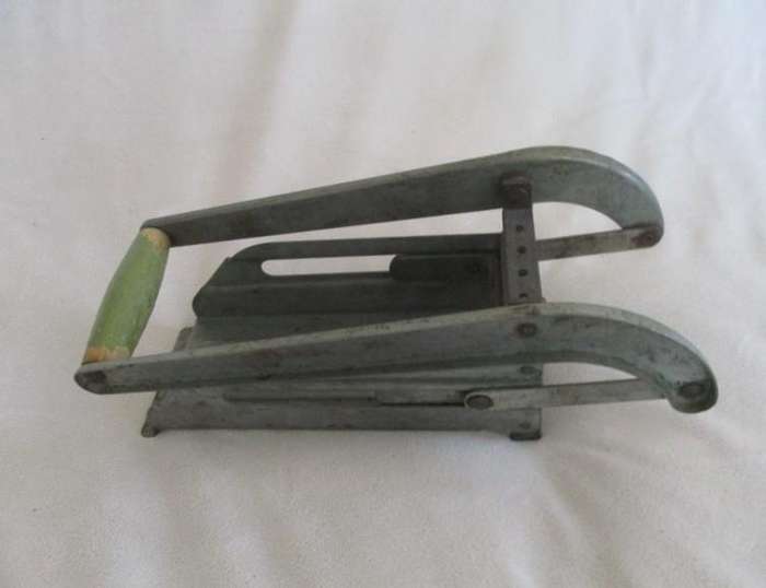 Two vintage potato kitchen utensils - masher and french fry cutter