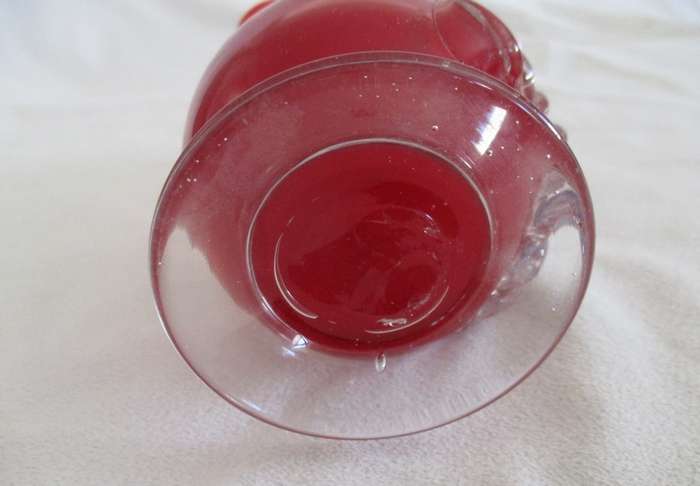 Vintage 18cm tall red hand blown art glass vase with fluted rim and applied floral design